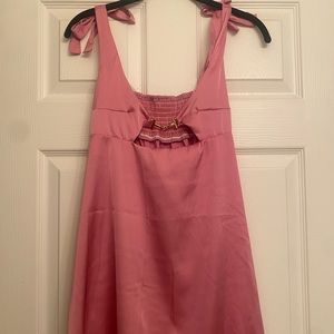 Pink silk dress with adjustable straps.